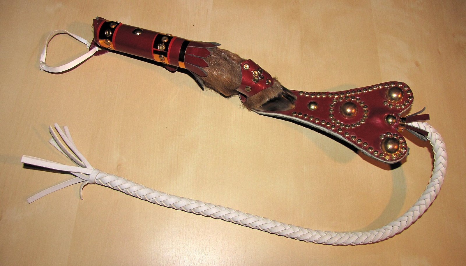 A kamcha with a braided lash and leather-covered handle