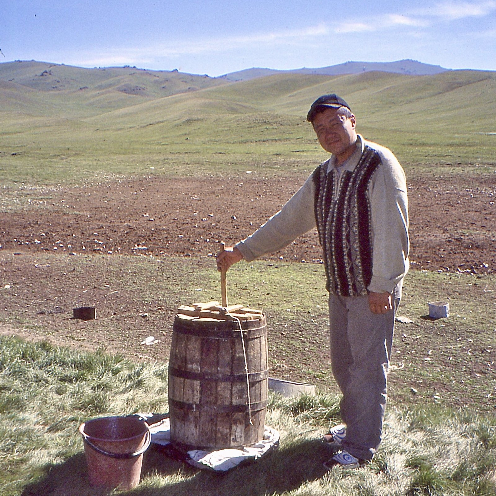 A semi nomadic cattle raiser preparing mare kumis (qymiz, kımız) in the Song Kol area, Kyrgizstan, July 2004