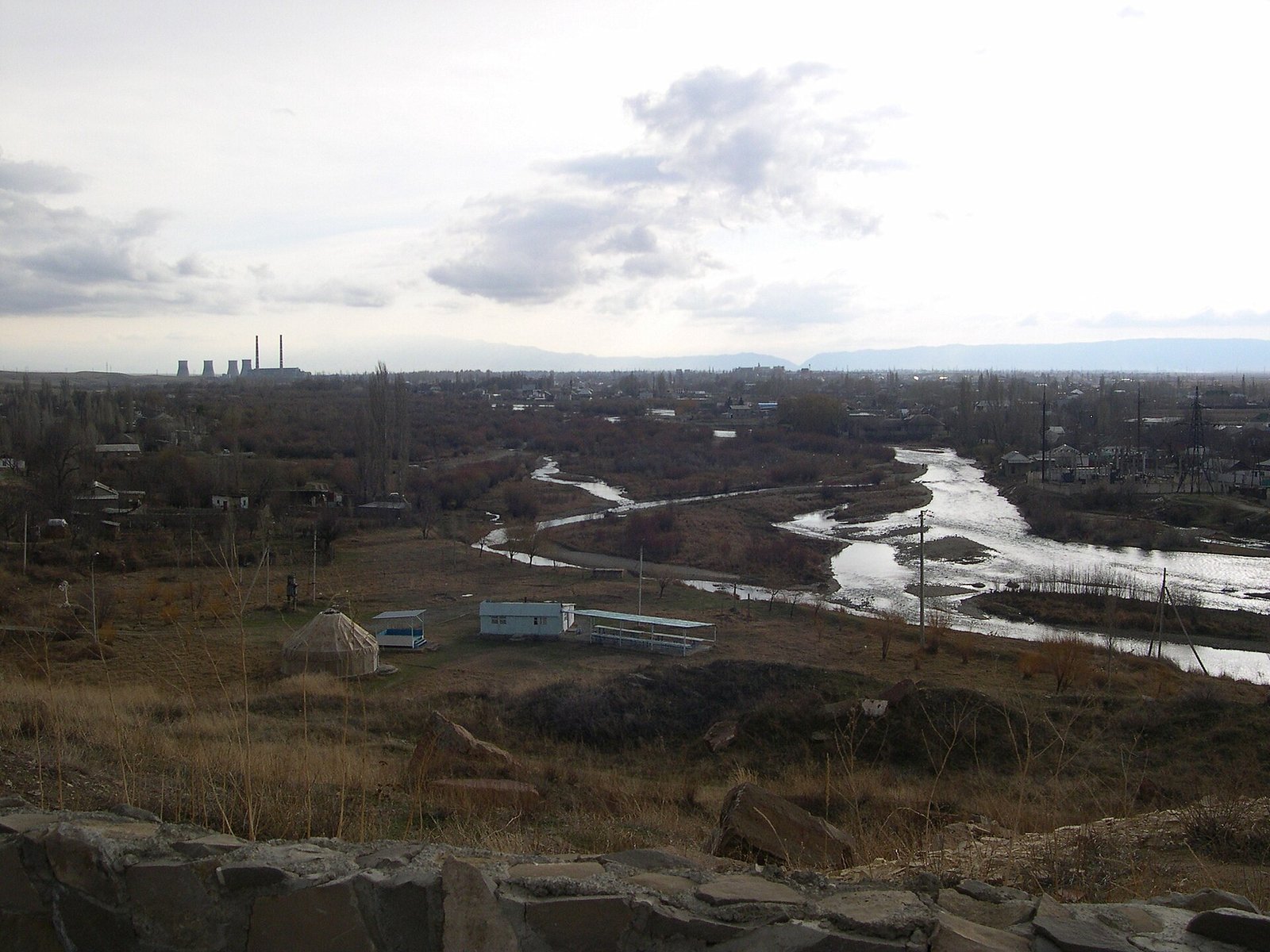 This river starts in the mountains of Kyrgyzstan and winds down into Kazakhstan. The right side of the river is the city of Taraz. Check out the yurt on the left side though!