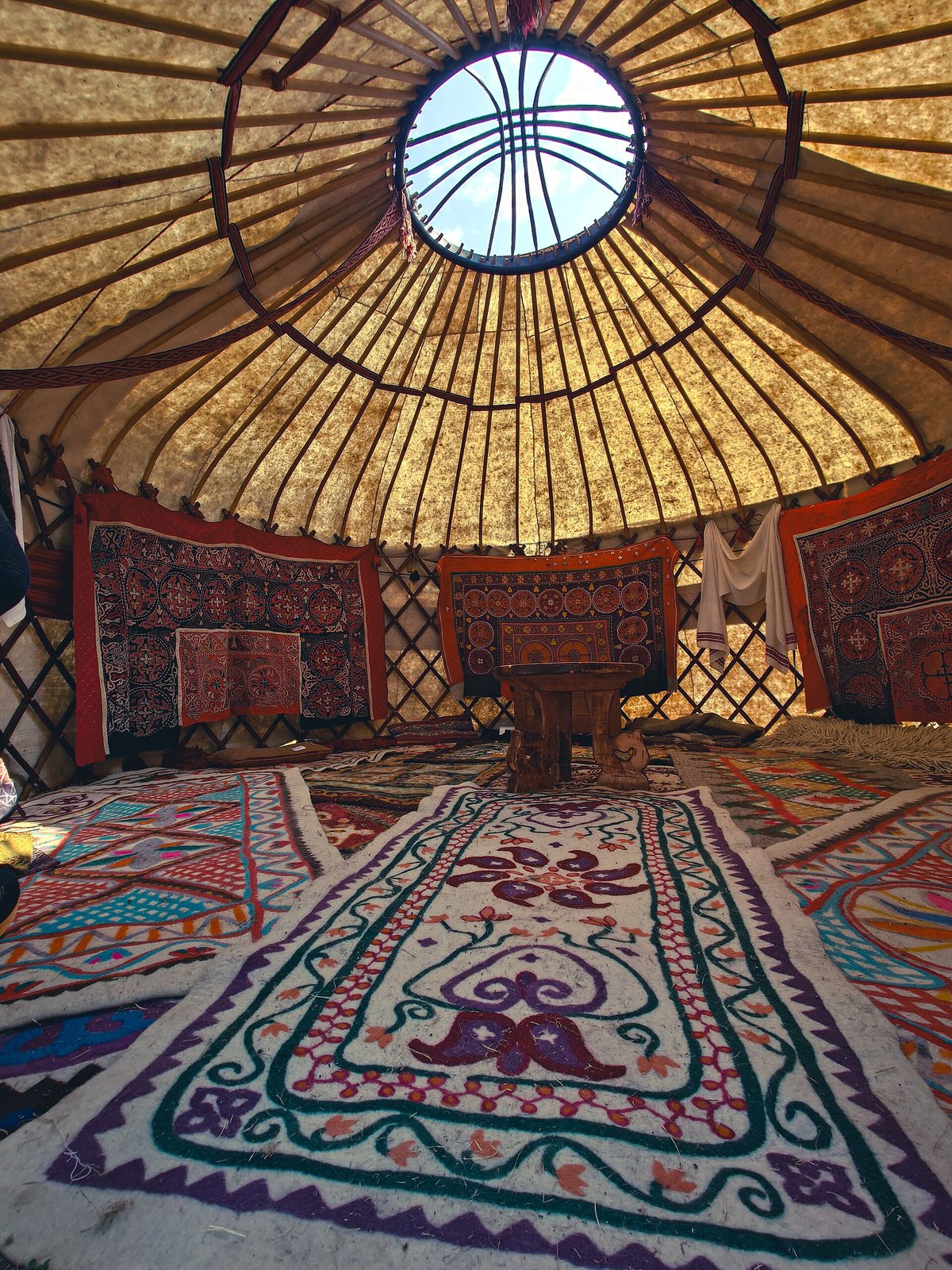 Inside a yurt, with felt carpets and the roof ring